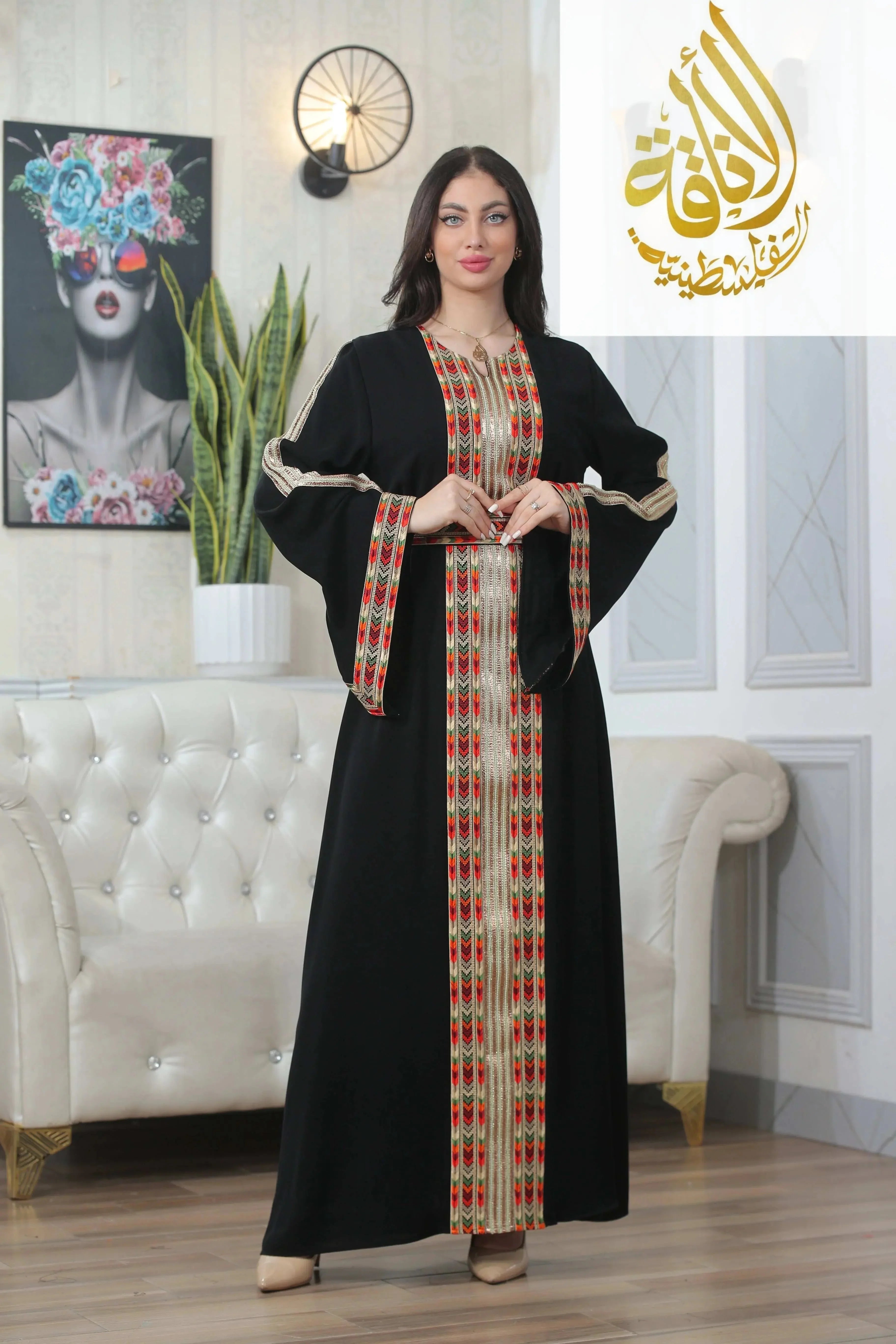 Palestinian Elegance Zena Embroidered Thoub in black with traditional red and gold embroidery on front and sleeves