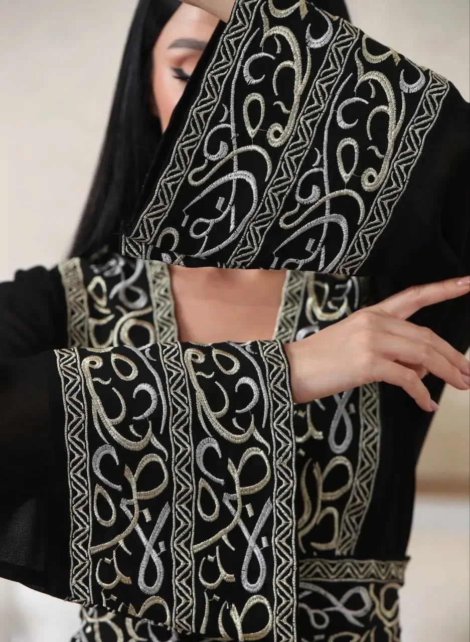 Black Arabic letter embroidered cardigan with intricate silver and gold embroidery on sleeves and front panel