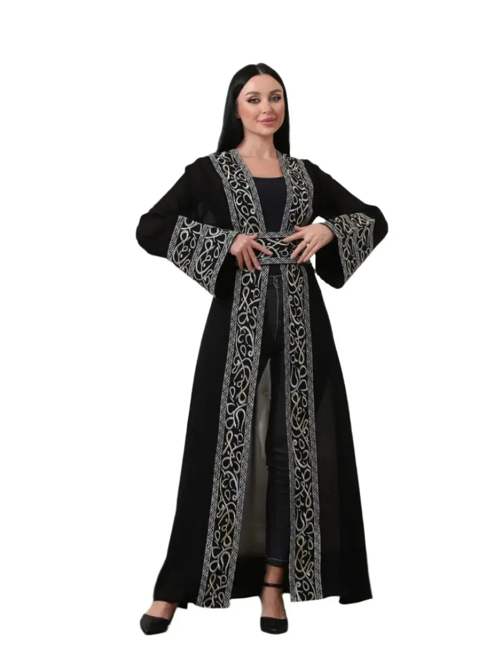 Black Arabic letter embroidered cardigan with intricate silver designs worn by woman from Palestinian Elegance