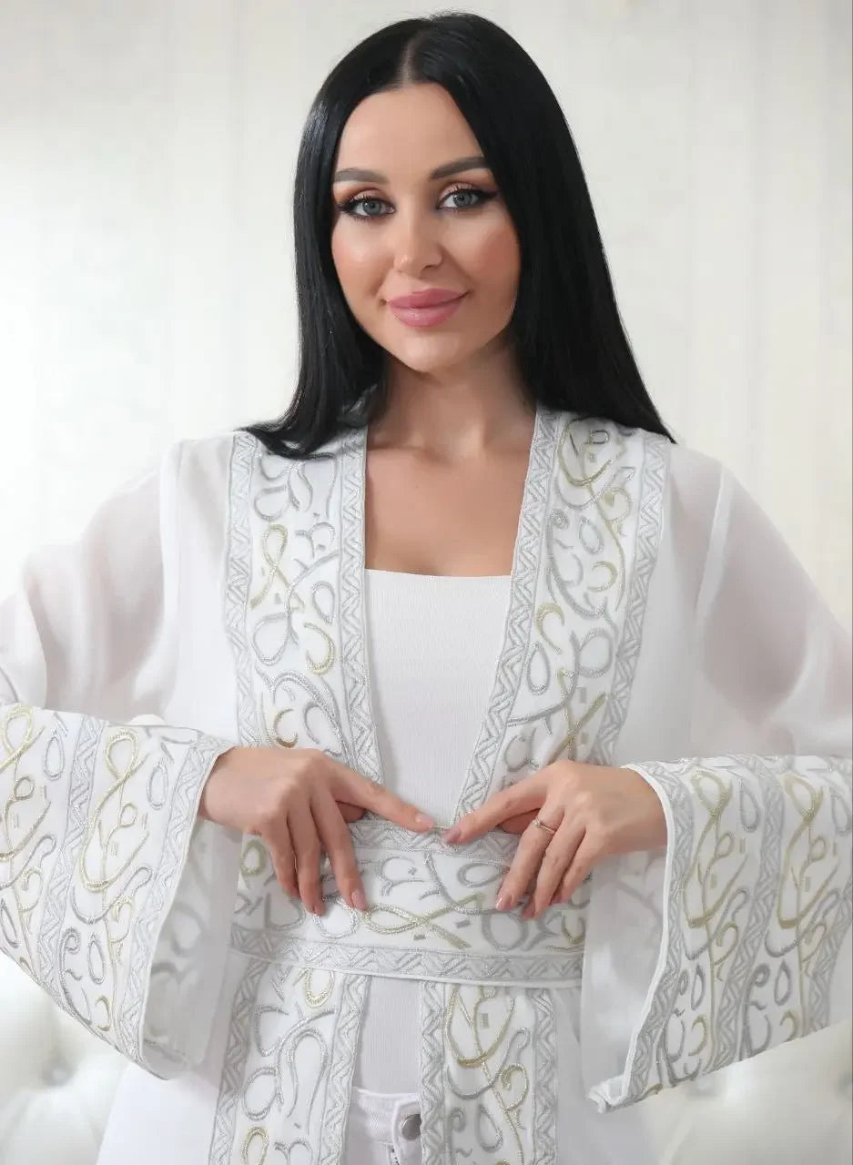 White Arabic letter embroidered cardigan with intricate calligraphy design on sleeves and front by Palestinian Elegance