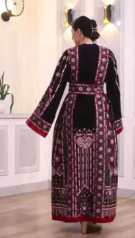 Palestinian Elegance embroidered manjal thoub dress with intricate red and white embroidery on black fabric