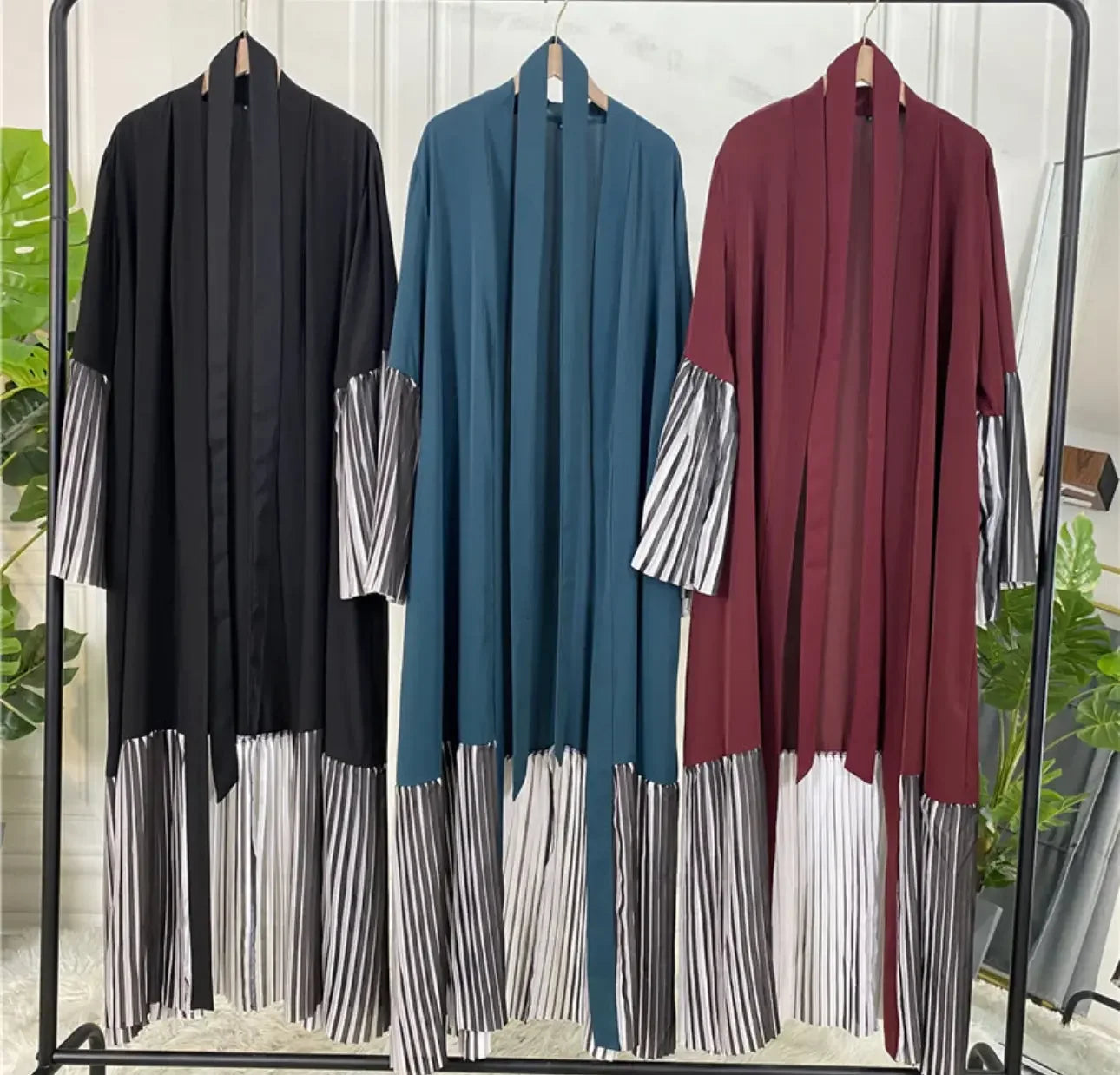 Palestinian Elegance flare sleeve abaya in black blue and maroon with striped flare sleeves and hem on hangers
