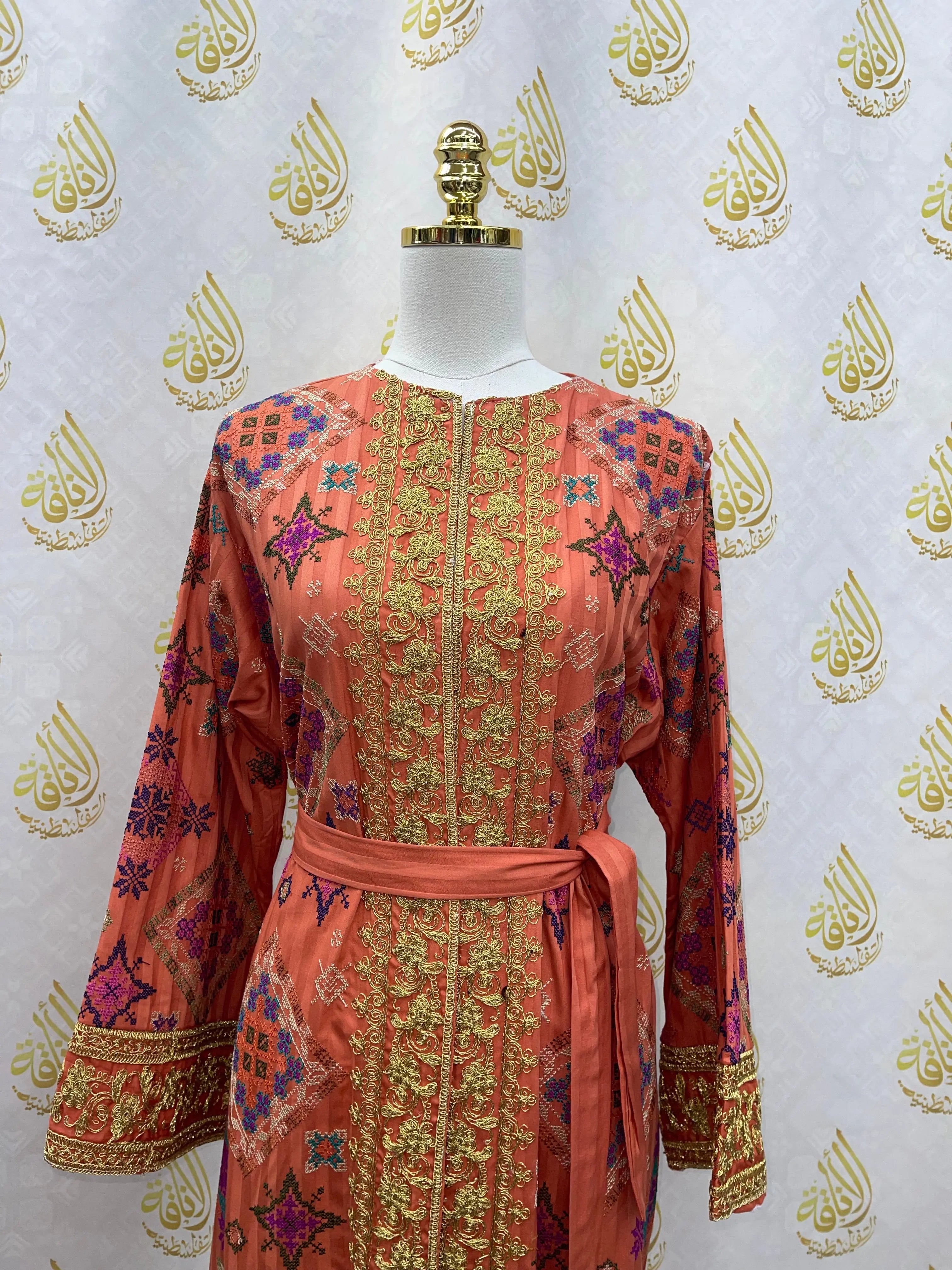 Palestinian Elegance Gabani embroidered long cardigan in coral with intricate gold and colorful embroidery details