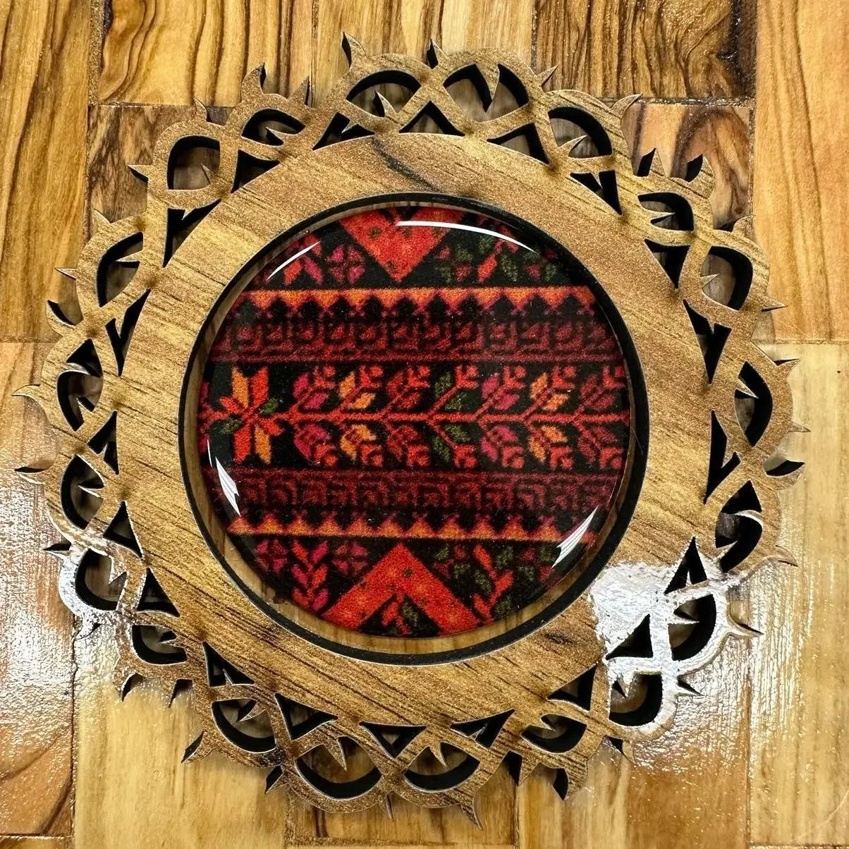 Handmade Palestine map wooden frame with intricate carved design and traditional red patterned fabric inside
