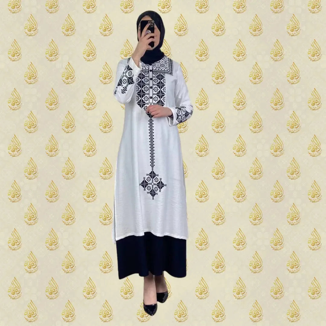 Palestinian Elegance vintage embroidered dress in white with black geometric patterns and long sleeves