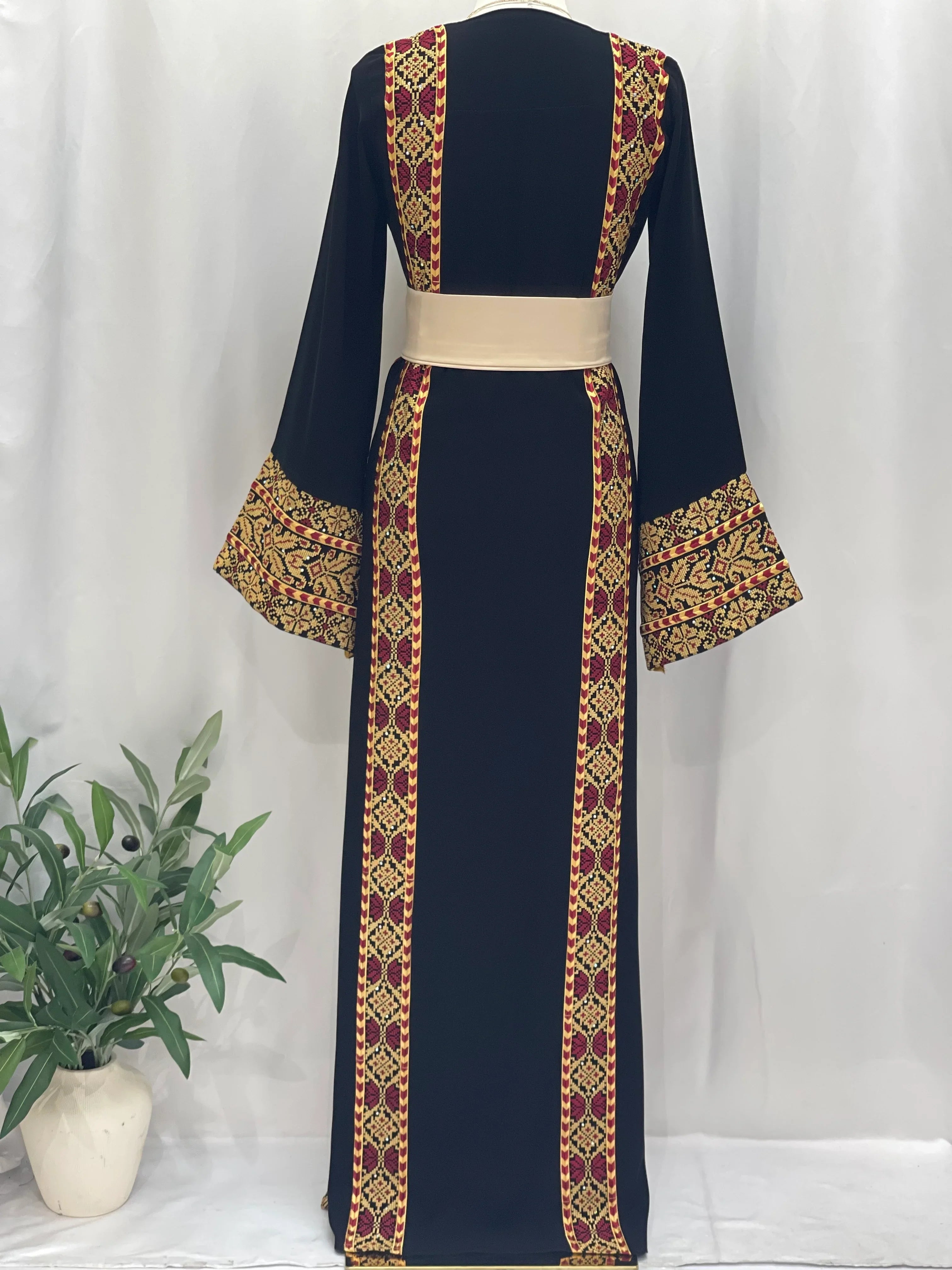 Black Palestinian embroidered thoub with intricate red and gold embroidery on sleeves and vertical panels