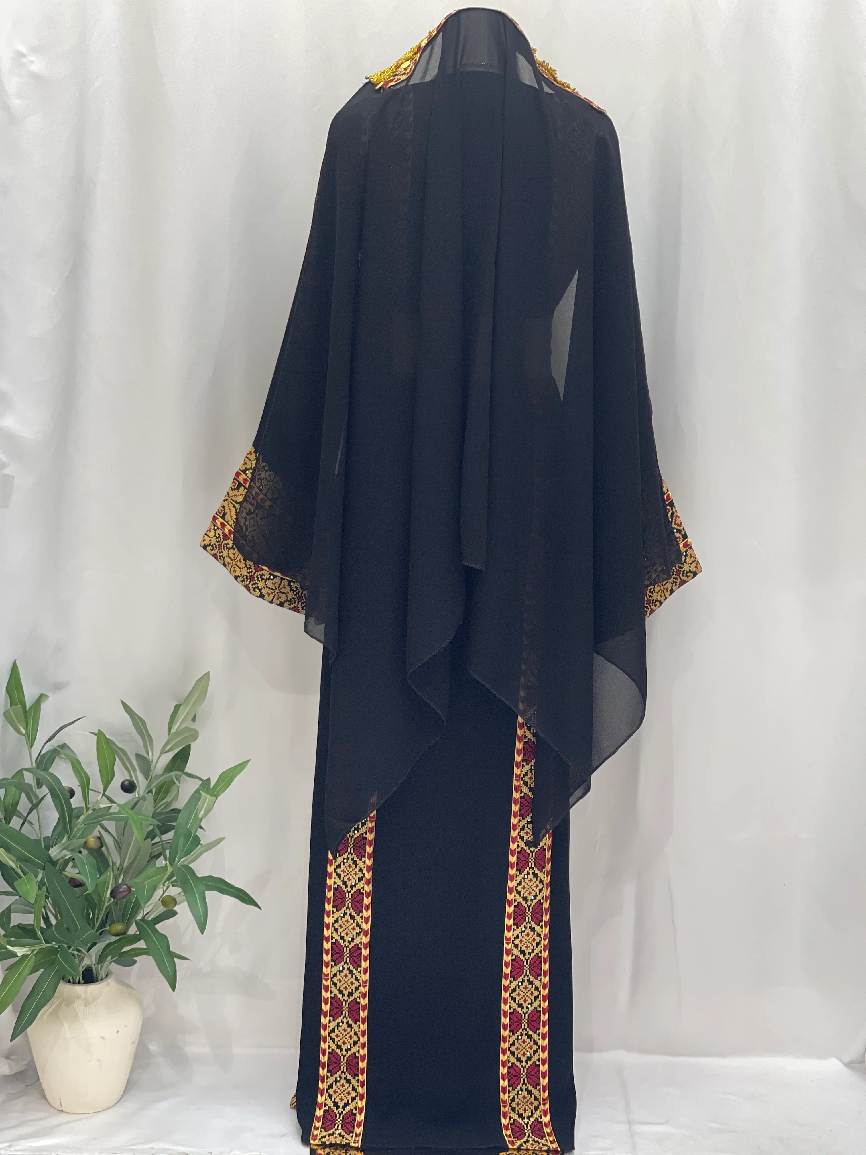 Palestinian embroidered thoub in black with traditional colorful embroidery by Palestinian Elegance