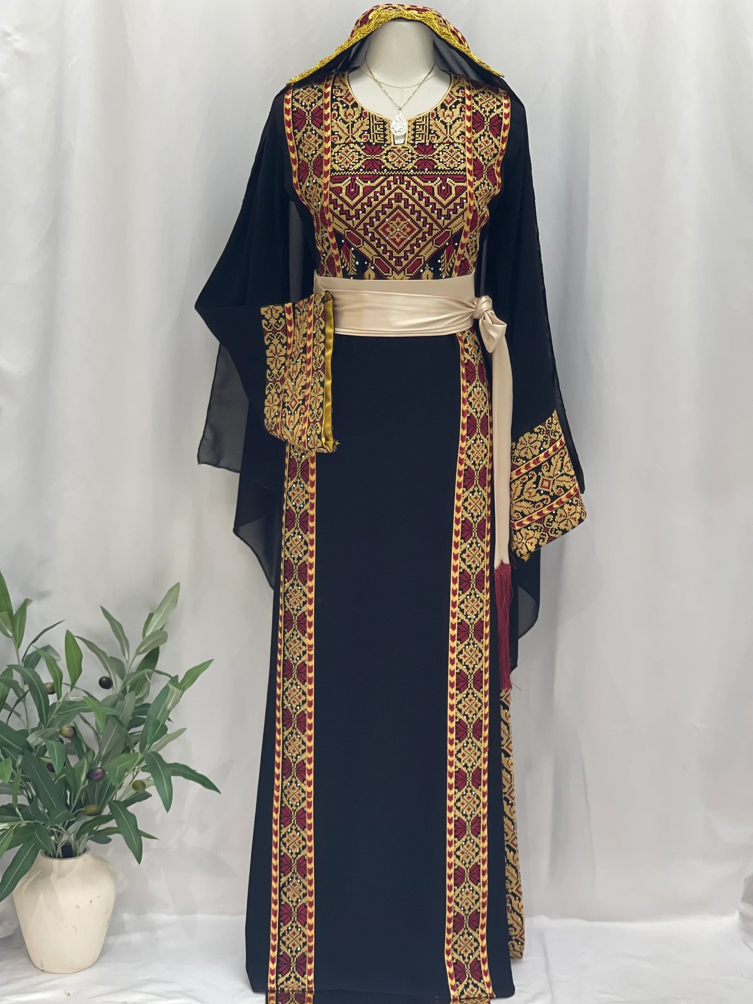Palestinian Elegance black Palestinian embroidered thoub with intricate red and gold embroidery and beige belt