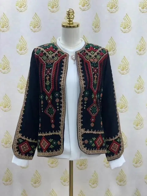 Palestinian Elegance traditional Palestinian jacket in black with colorful detailed embroidery on a mannequin
