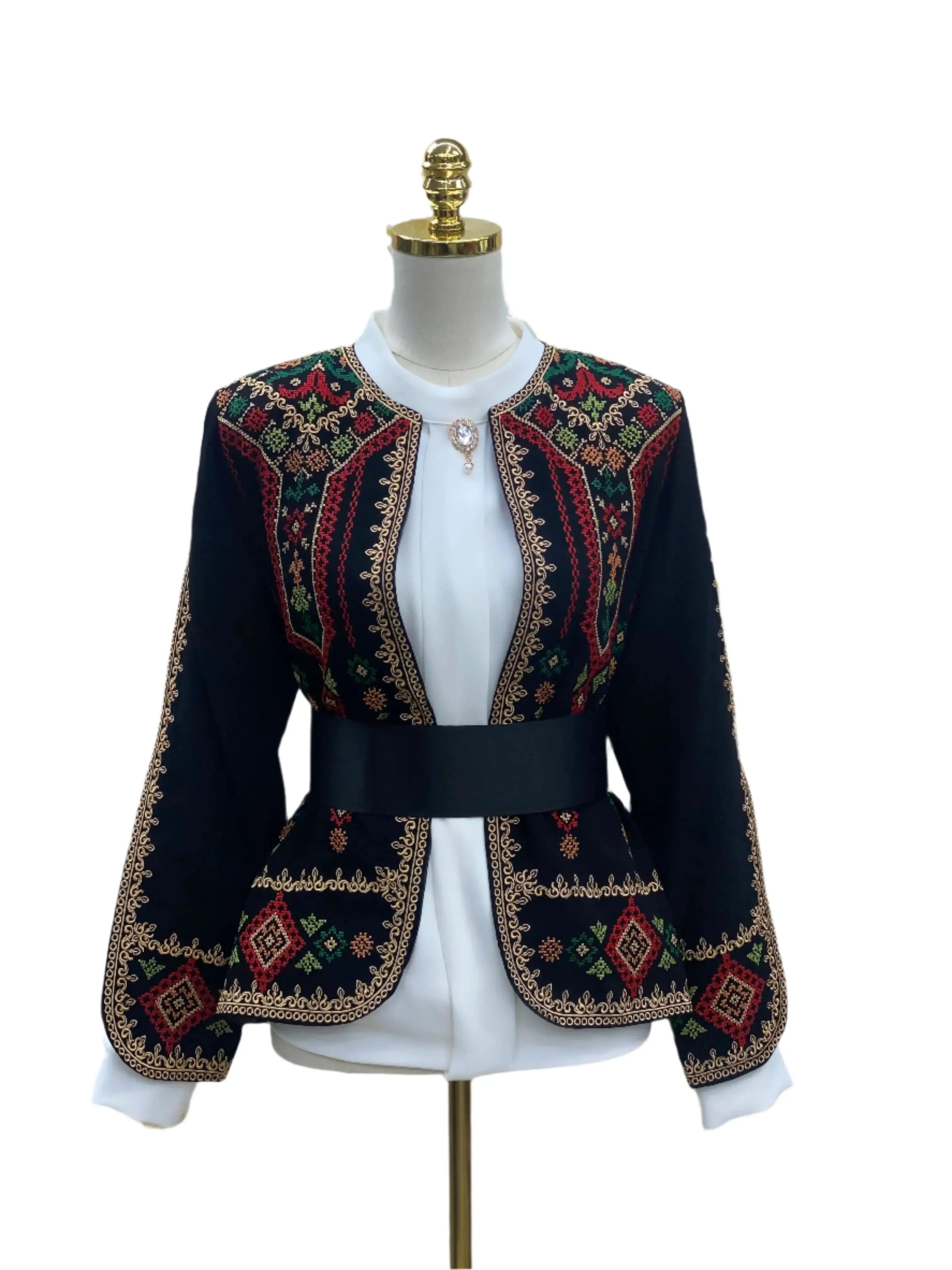 Traditional Palestinian jacket by Palestinian Elegance with intricate red green and gold embroidery on black fabric