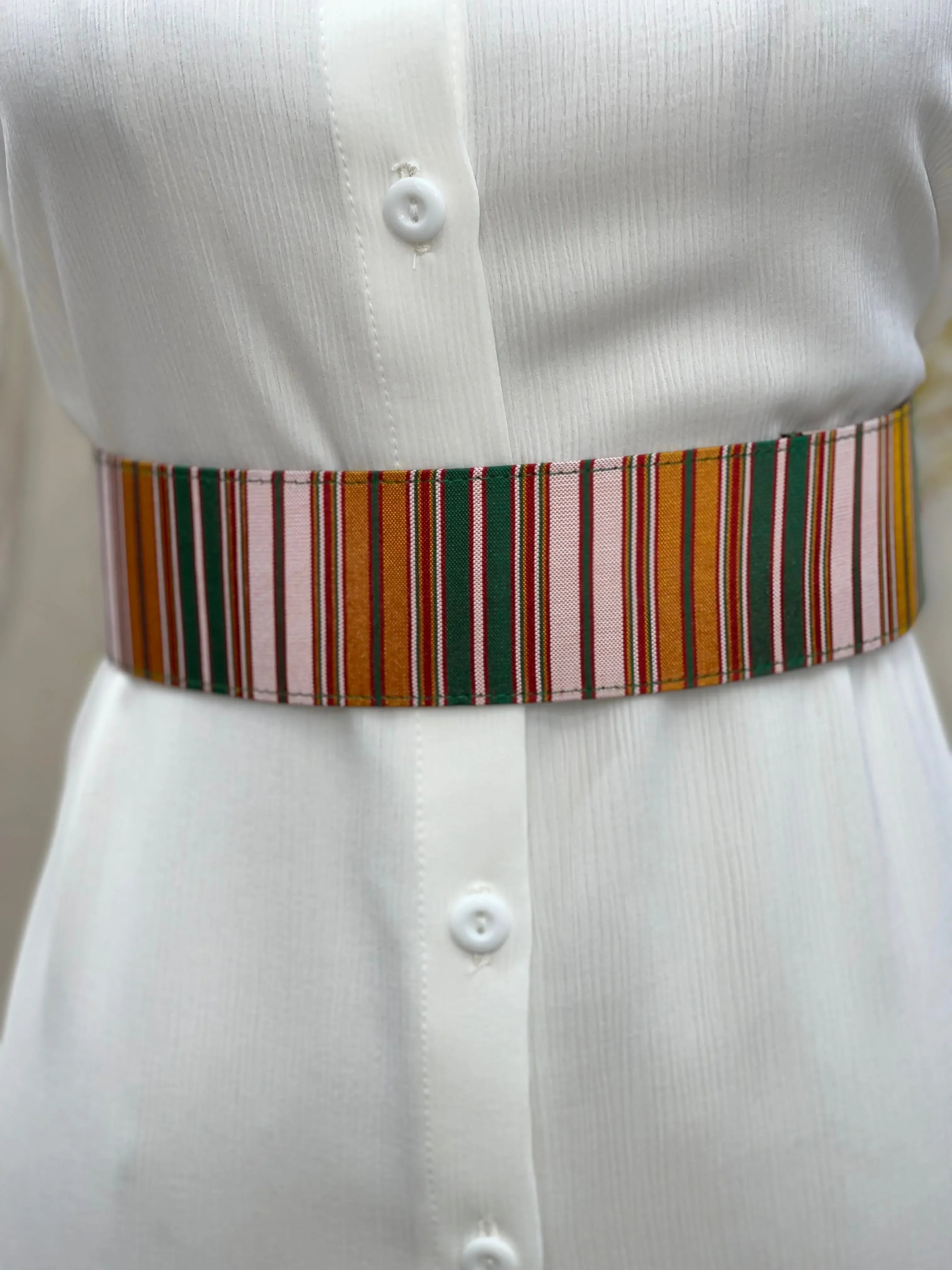 Palestinian Elegance striped satin waist belt in warm colors styled on white dress