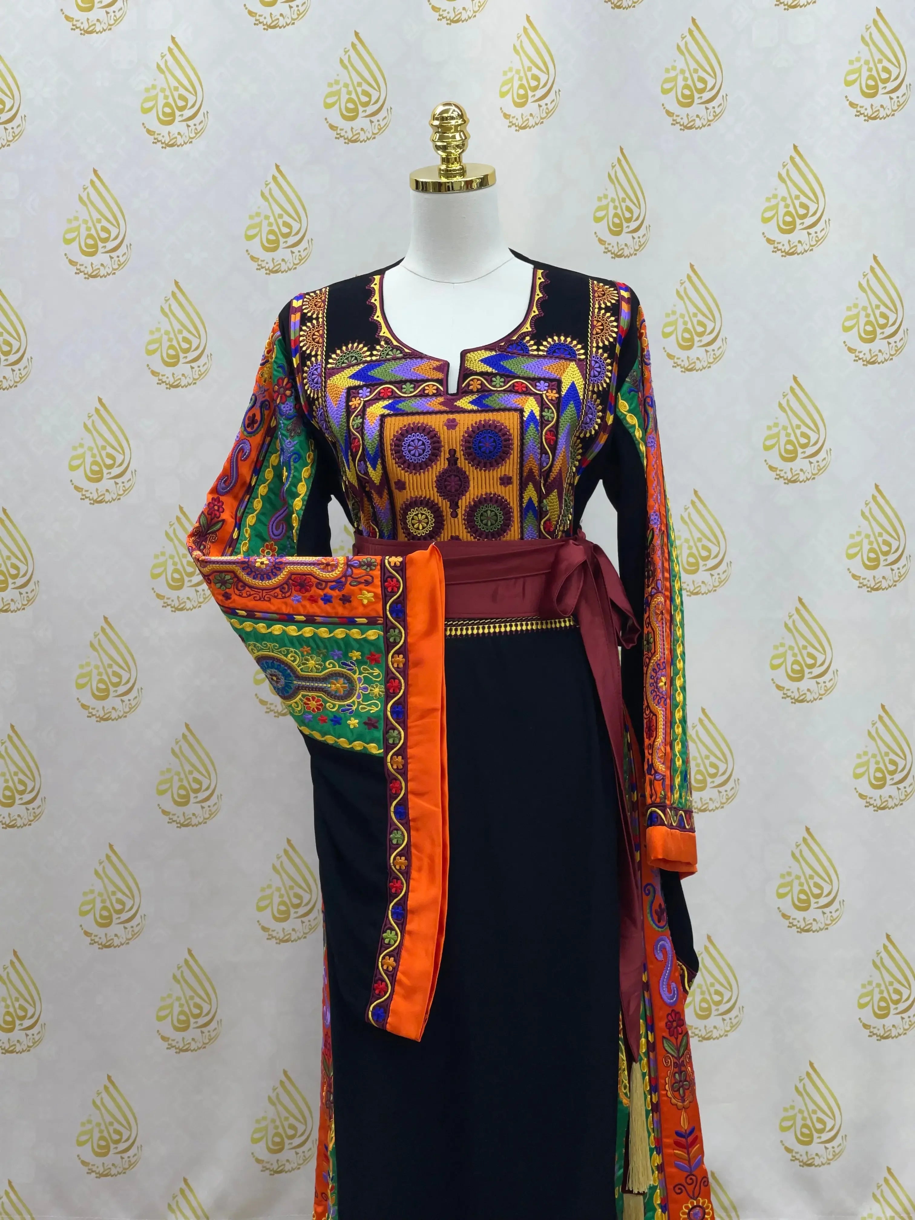 Palestinian Elegance embroidered dress with colorful traditional patterns and orange accents