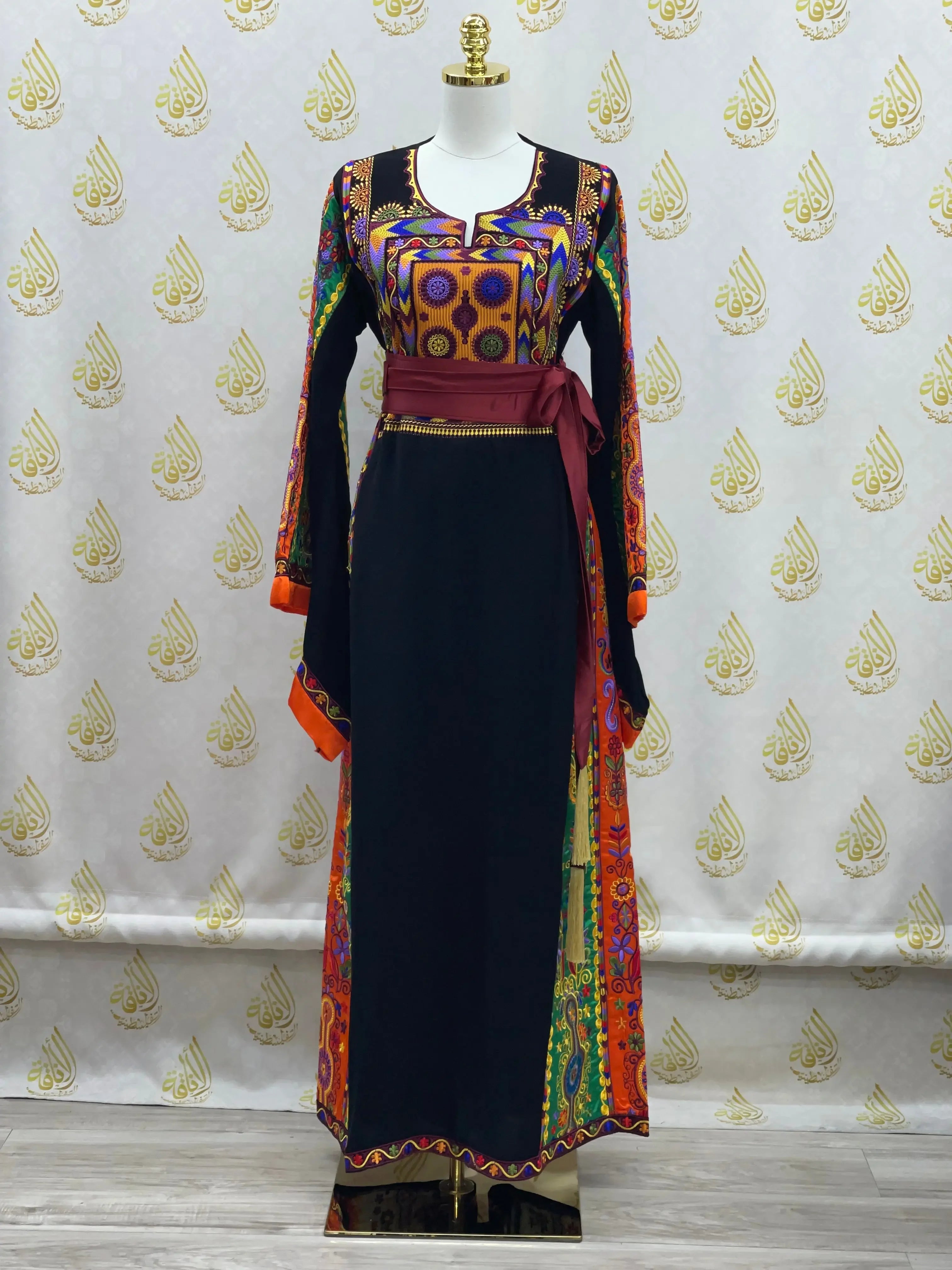 Palestinian Elegance embroidered black dress with colorful traditional patterns and burgundy waist sash