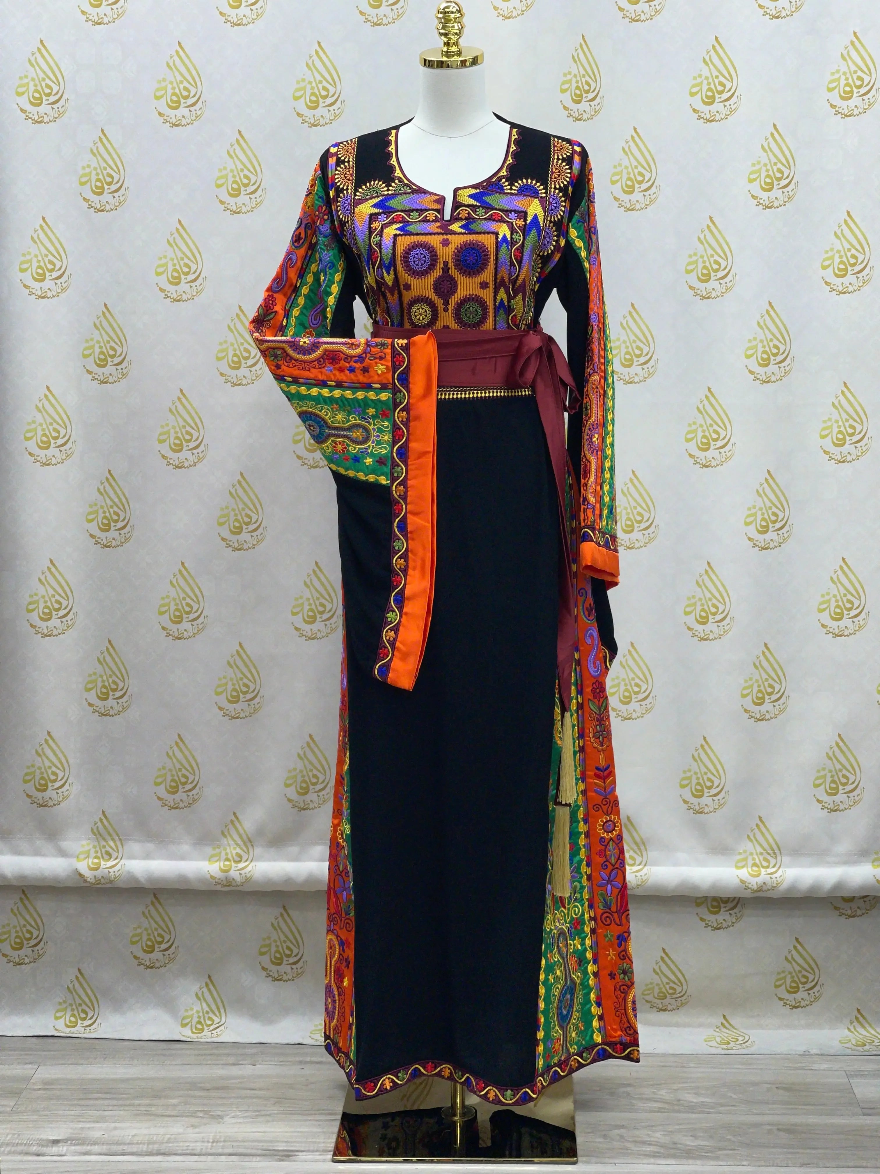 Palestinian Elegance embroidered long black dress with colorful traditional patterns and maroon sash belt