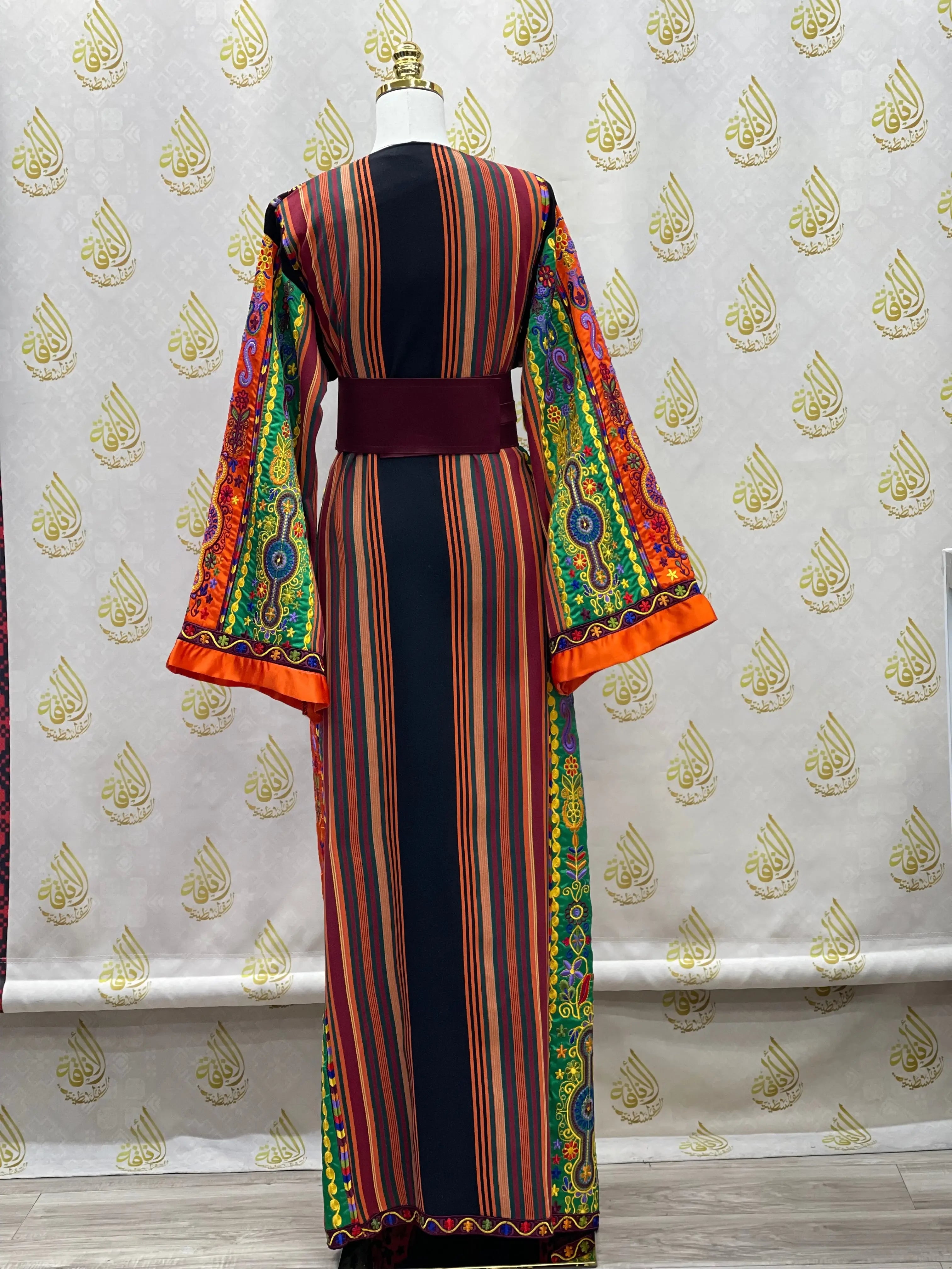 Palestinian Elegance embroidered dress with colorful striped front and vibrant floral sleeves