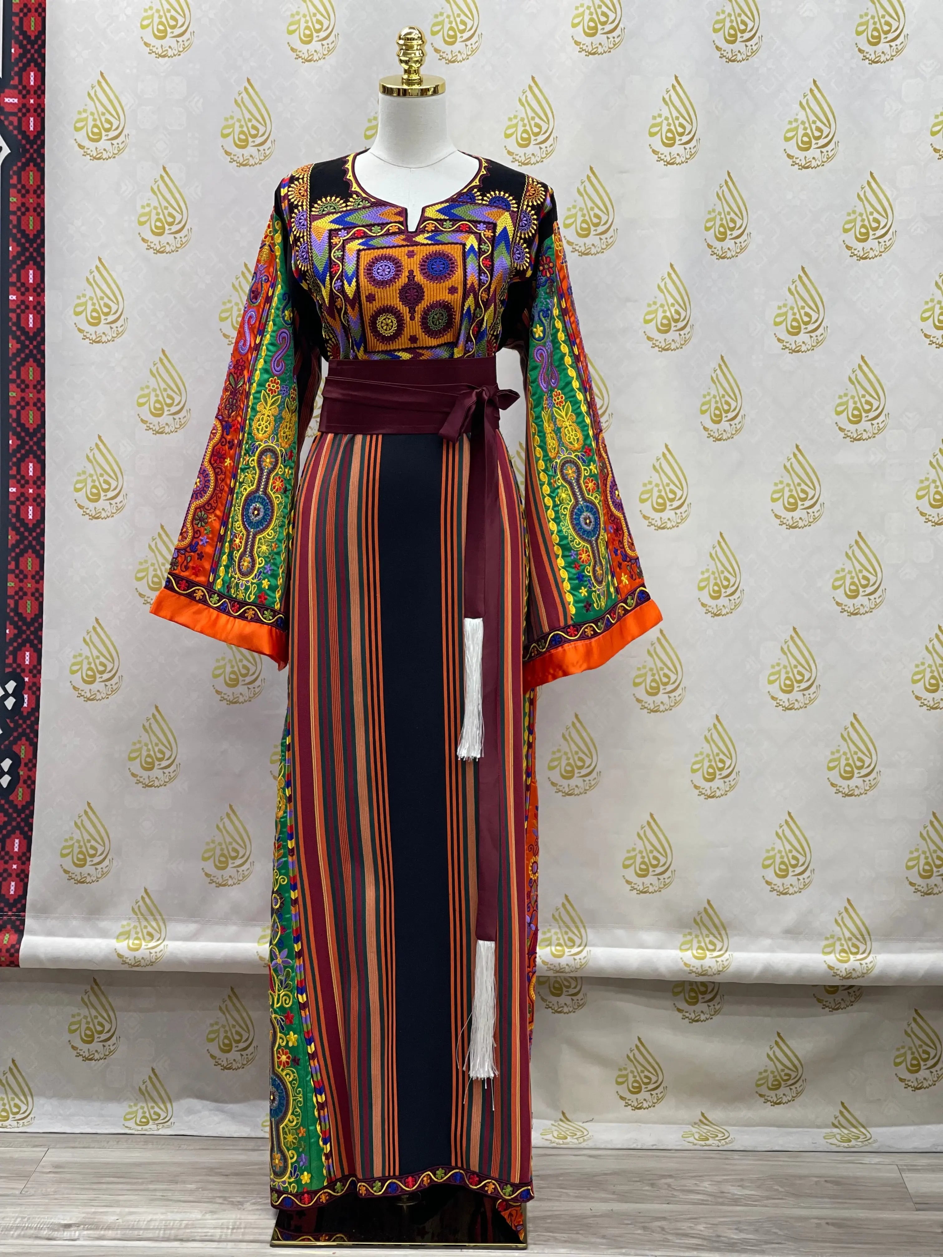 Colorful embroidered traditional dress by Palestinian Elegance with intricate patterns and long sleeves